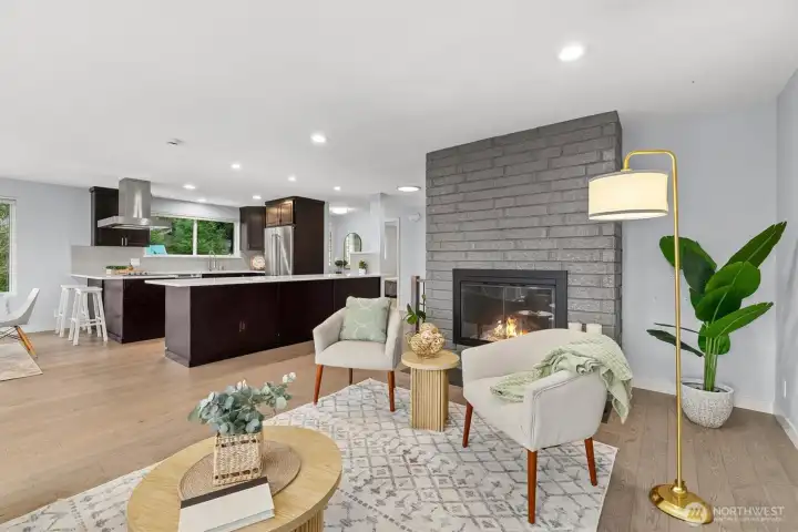 Open-concept living area with fireplace, spacious seating area, and seamless connection to the kitchen and dining spaces for easy entertaining.