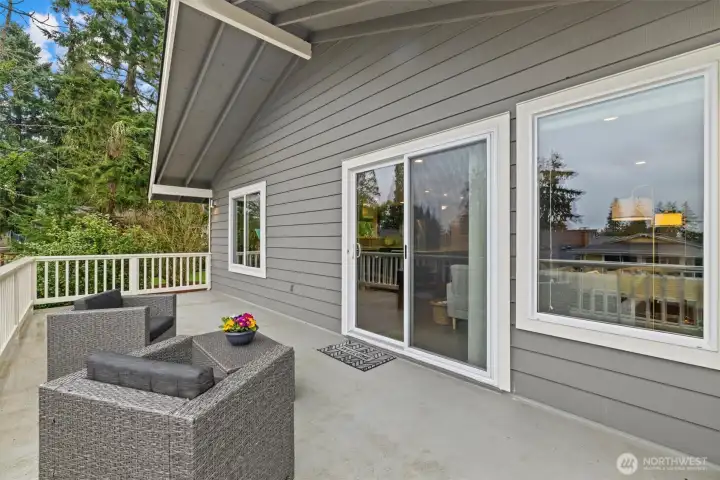 Deck access from the home with sliding glass doors, ideal for seamless indoor-outdoor living and gatherings in a peaceful setting.