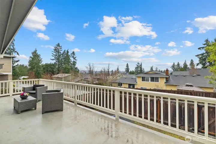 Elevated deck with sunset and territorial views, offering a quiet outdoor retreat above the fully fenced yard.