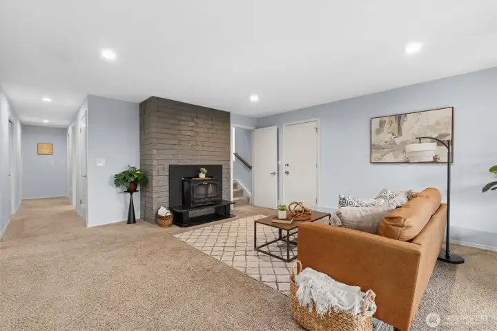 Spacious rec room with fireplace, flexible seating area, and open layout ideal for media, play, or entertaining.