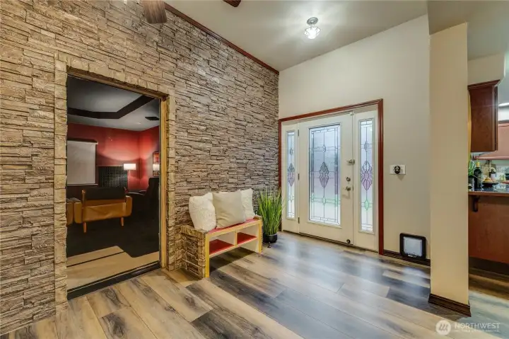 NEW - Permitted Addition added flex space w/soaring ceiling, faux stone wall, built in shoe bench/storage, all drenched in natural light