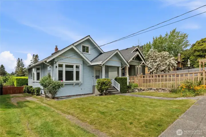 Charming Craftsman home with inviting curb appeal and manicured landscaping.