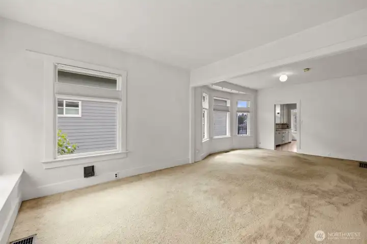 Light-filled living room featuring large windows and an open, inviting feel.