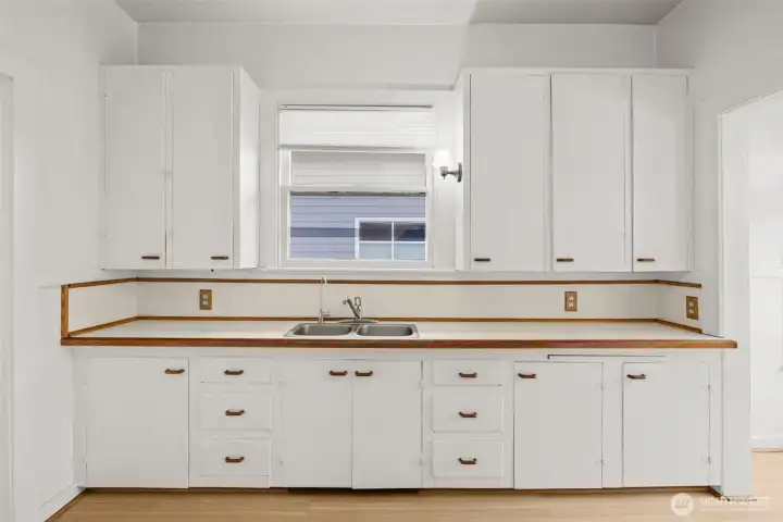 Spacious kitchen featuring abundant cabinetry and ample countertop workspace.