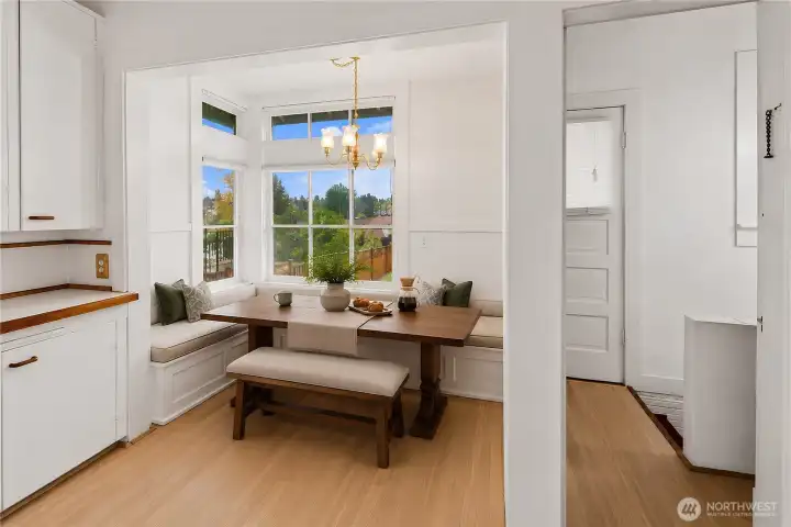 Charming breakfast nook perfect for morning coffee and casual dining. virtually staged.
