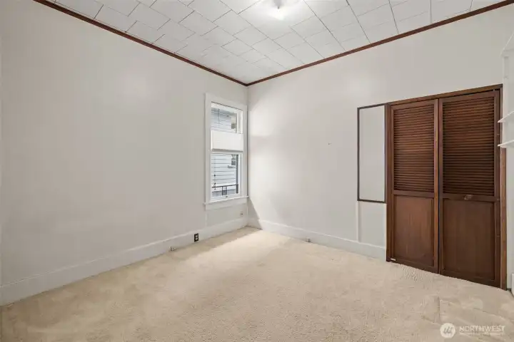 Spacious bedroom with tall ceilings.