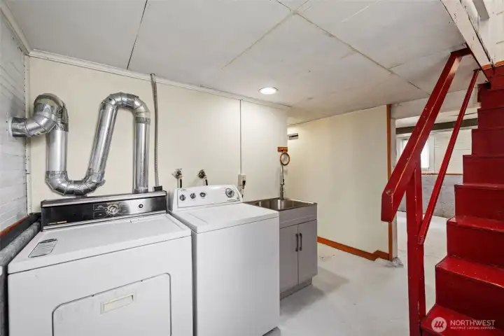 Utility and laundry area in basement.