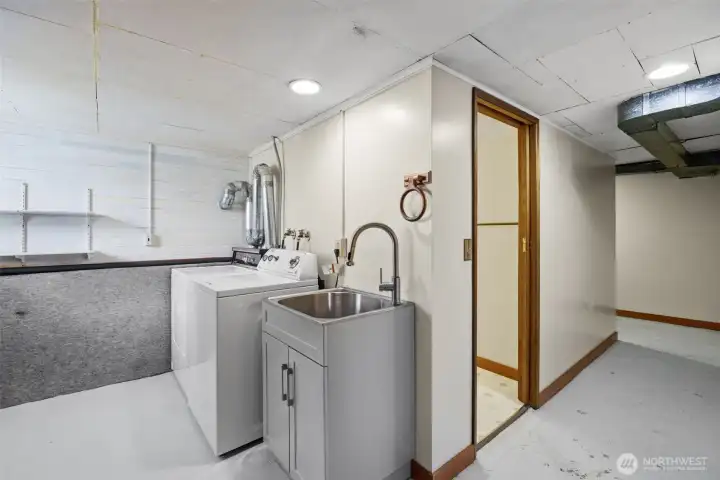 Utility and laundry area in basement.