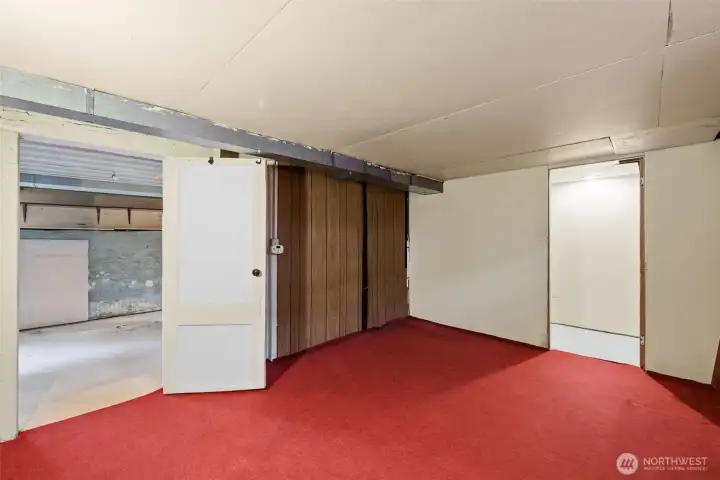 Flexible lower-level room ready for recreation, hobbies, or future updates.
