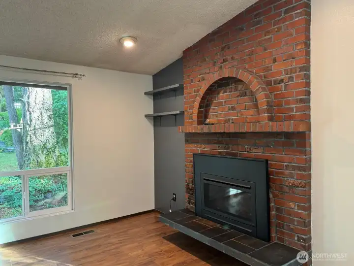The gas insert in this unique fireplace will keep you warm as you look out the windows. The gas insert in this unique fireplace will keep you warm as you look out the windows.