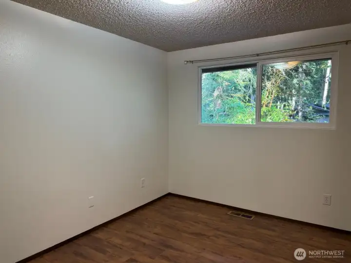 The second bedroom mirrors the first with ample windows. The second bedroom mirrors the first with ample windows.