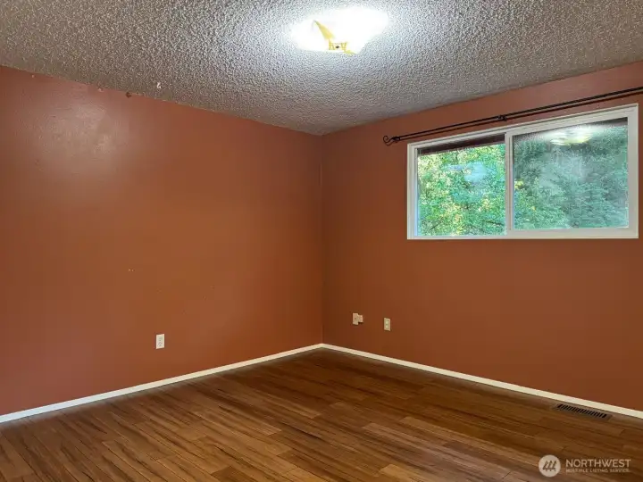 The primary bedroom overlooks the greenery of the backyard. The primary bedroom overlooks the greenery of the backyard.