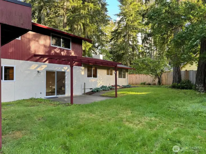 A small incline at the end of the yard leads up to a second patio. A small incline at the end of the yard leads up to a second patio.