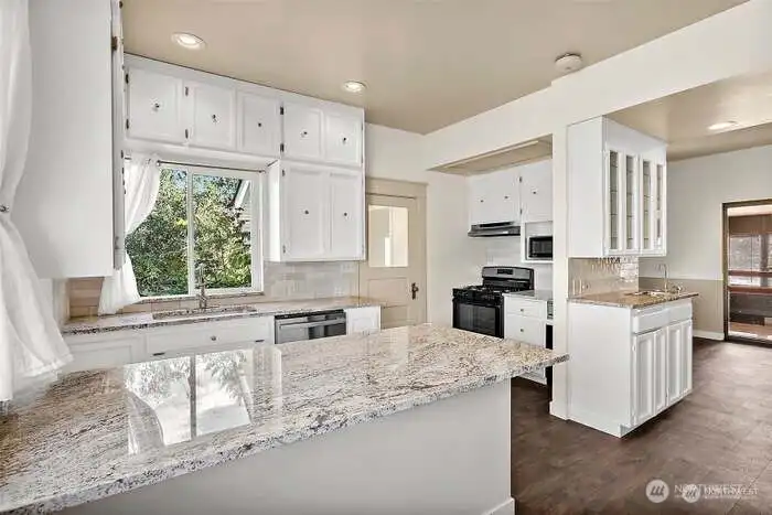 Granite Countertops and Nice Engineered Wood Floors - Flows thru to Sunroom Area Granite Countertops and Nice Engineered Wood Floors - Flows thru to Sunroom Area