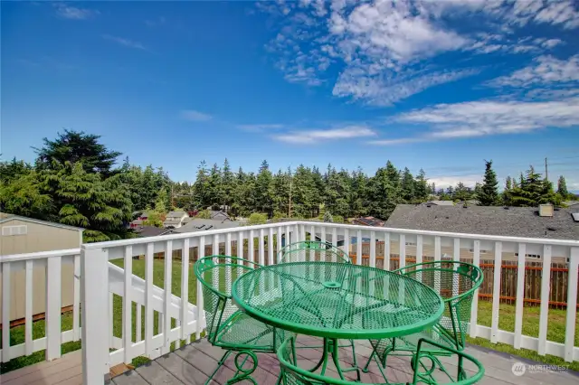 The deck stairs lead into the backyard