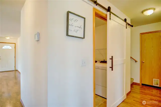 This lovely barn door leads to the utility and powder room