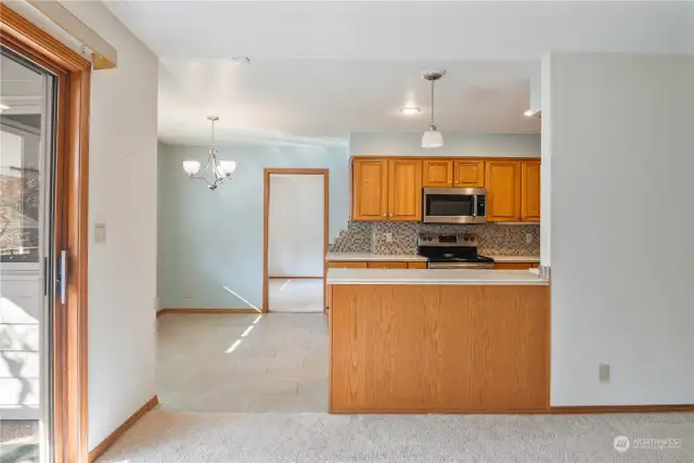 Updated appliances, solid surface countertops and updated backsplash are features of the large galley kitchen.