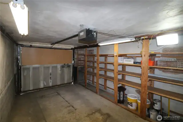 One car garage with storage shelves. There is also a shared laundry room on this level.