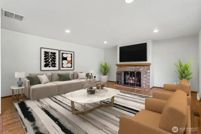 Virtually staged. The family room with a cozy fireplace invites relaxation.
