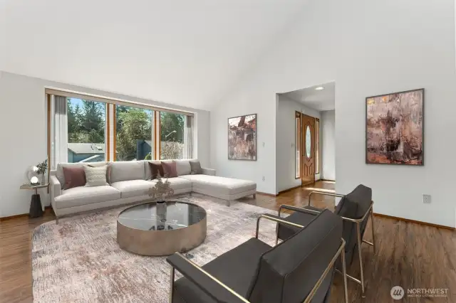 Virtually staged. A row of windows fill the living room with natural light.