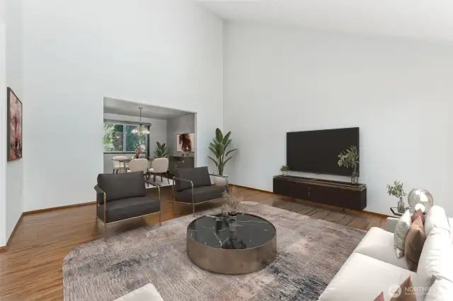 Virtually staged. The living room flows seamlessly into the dining room.