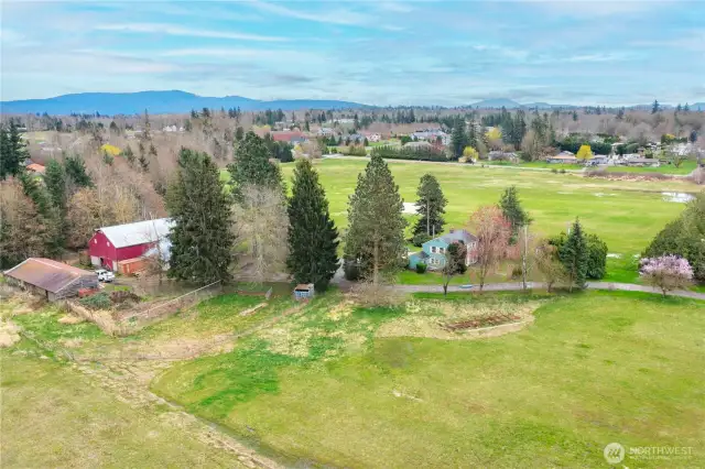 Additional large outbuilding next to the barn, you'll have plenty of room to store your equipment. Salmon bearing creek is in the trees behind the barn.