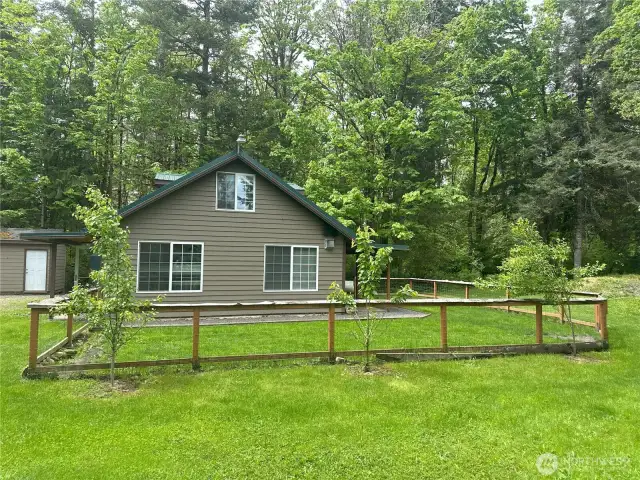Fruit trees with fenced yard.