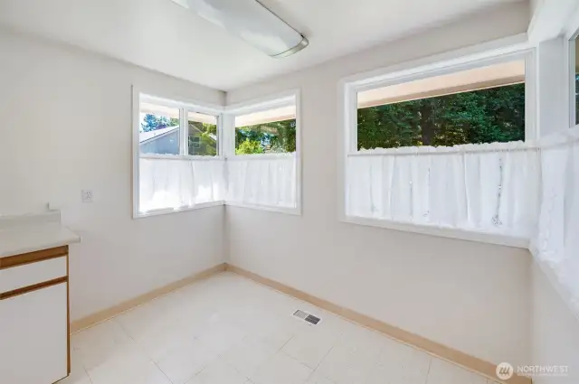 Beautiful and Cozy Kitchen Nook. Sit here in here and enjoy the view you create from all of these window!