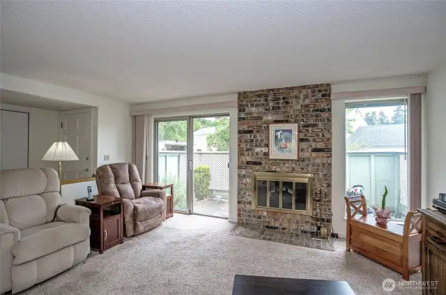 Living room with wood buring fireplace. Has an electric 'fake fire' in there now.