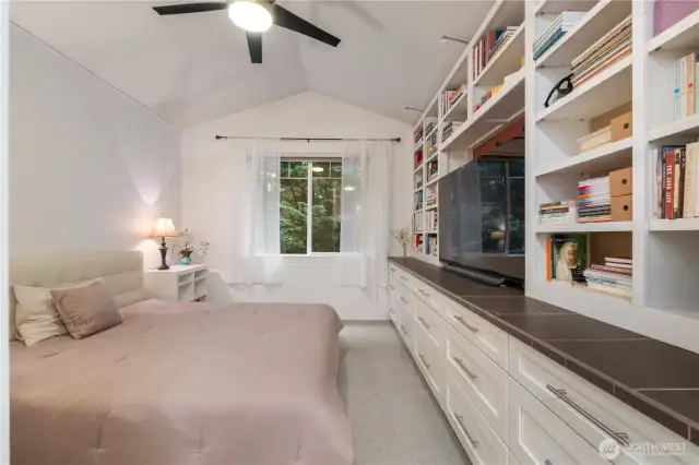 Dawning a spacious vaulted ceiling, Window  Framed in Custom Trim & Mill Work, Custom Built in Shelving & Dresser with a Tile Counter top, & Smooth Opening Drawers. This Master Suite is strikingly sophisticated.