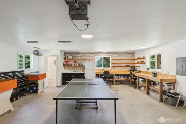 Garage with fridge, sink, counters and half bathroom