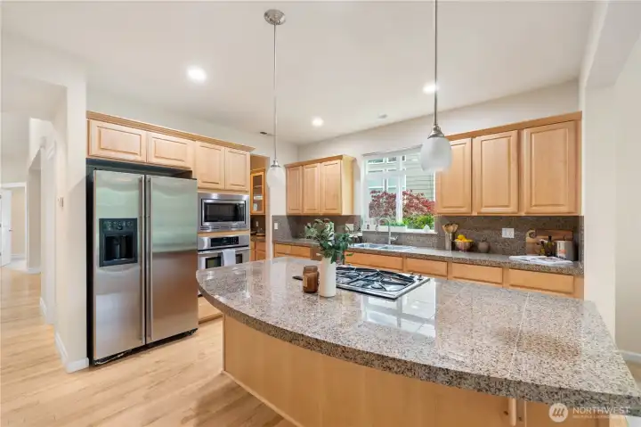 Granite tile counters and beautiful natural cabinets...Add some decorative hardware or enjoy this clean and neutral look!