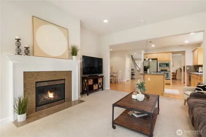 This living room features a beautiful gas fireplace and provides access to the back patio for outdoor entertaining.