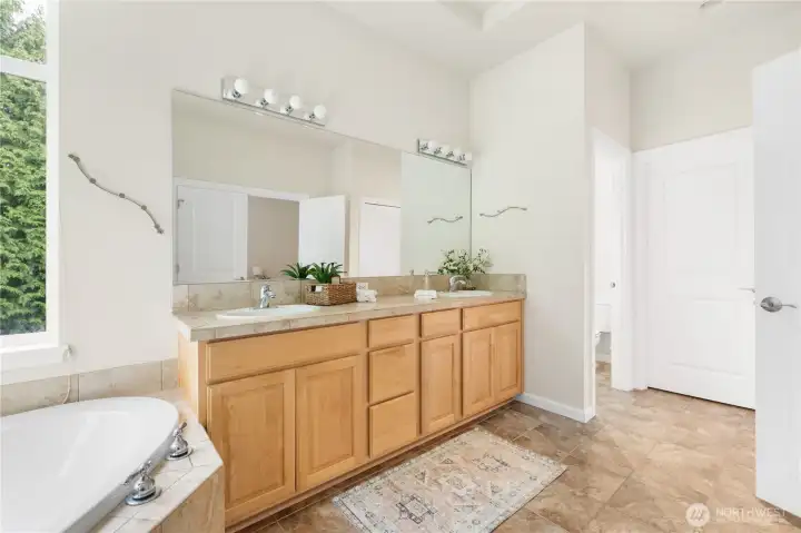 Double vanity with water closet and primary closet access on the other side.