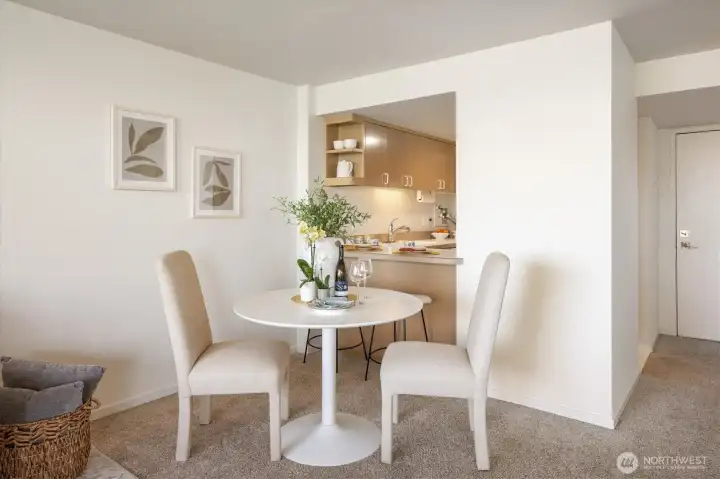 The dining area divides the Living Room from the charming Kitchen.