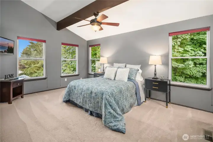 Primary bedroom with ceiling fan and gas fireplace