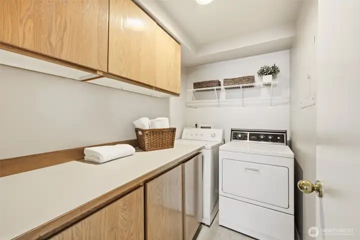 Large, dedicated laundry room with plenty of storage and counter space.