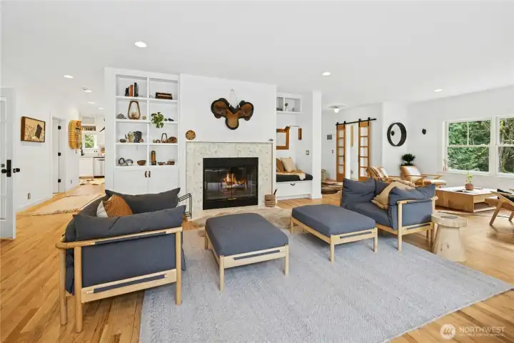 The remodeled main living area centers around a statement fireplace with custom built-ins, creating a polished yet welcoming gathering space. Open sightlines and abundant natural light connect the rooms seamlessly, ideal for entertaining, relaxing, and enjoying the tranquil views of the surrounding acreage.