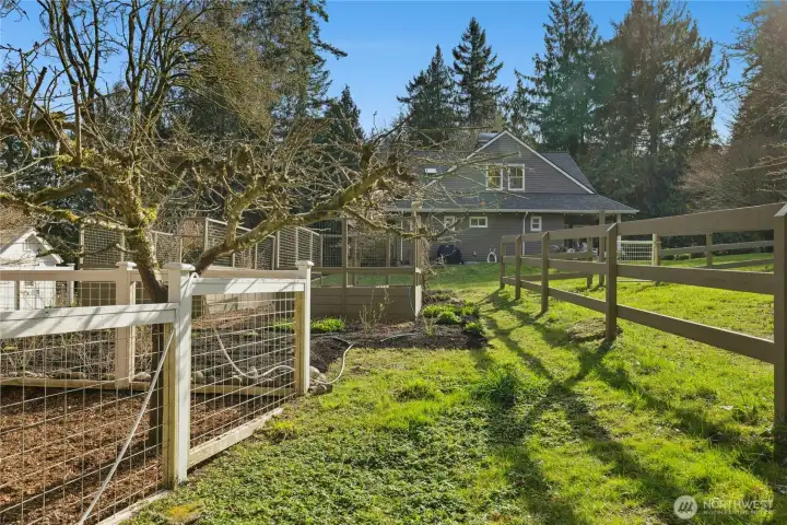 Fenced garden areas and orchard-style trees (cosmic crisp apples & plums) create a picturesque, productive landscape just beyond the home. This setting beautifully blends refined country living with everyday equestrian functionality.