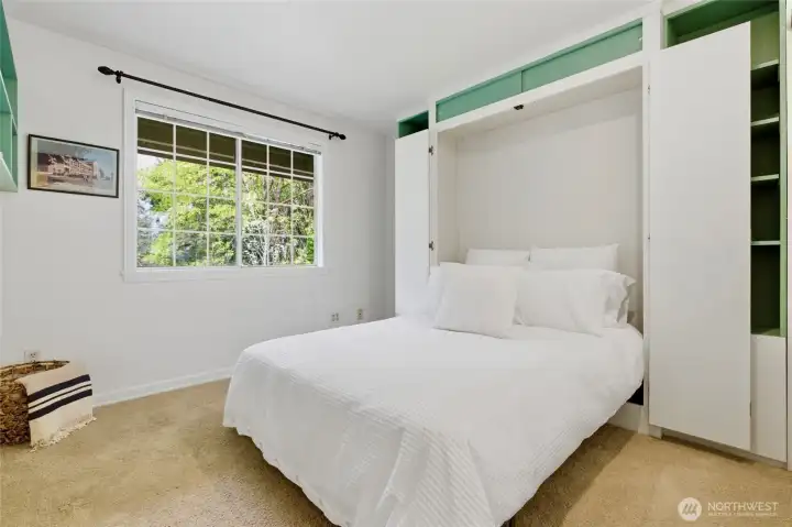 The second bedroom features a Murphy bed, offering a flexible space perfect for guests, a home office, or both.