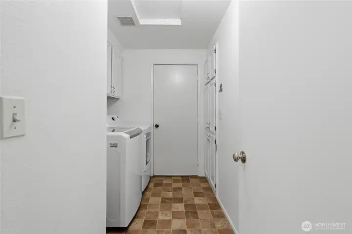 . A dedicated utility room with in-unit washer and dryer adds practicality and additional storage and opens directly to a spacious two-car garage.