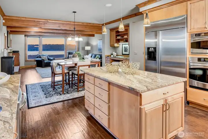 From the kitchen, everything opens up. The island overlooks the dining and living areas, with natural light and water views drawing you through the space. It’s an ideal layout for staying connected.