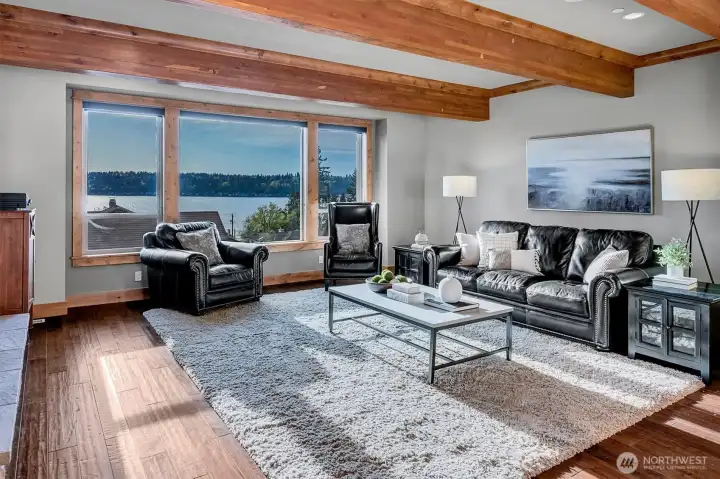 This is where everything comes together. Expansive windows frame the water, bringing in natural light and creating a constant connection to the outdoors. Exposed beams add warmth and character, while the space itself feels both open and comfortable.