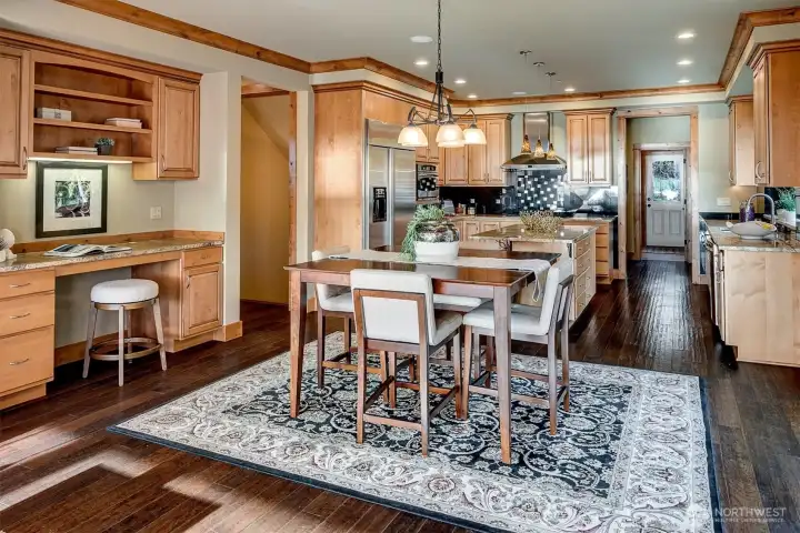 This wider perspective shows how thoughtfully everything comes together. The kitchen, dining area, and built-in workspace all connect.