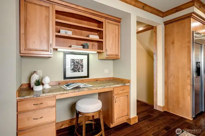 Tucked between the kitchen and the family room, this built-in workspace offers a practical spot to stay organized without feeling separate from the home.
