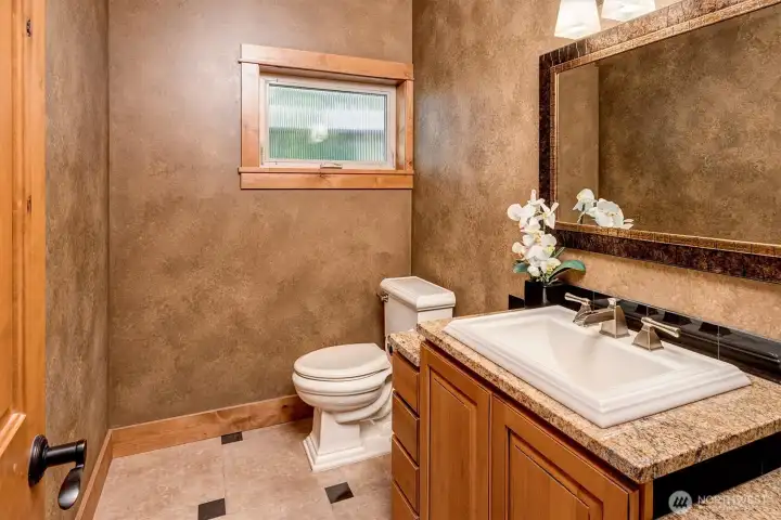 Warm finishes and thoughtful details make this powder room feel both inviting and elevated.