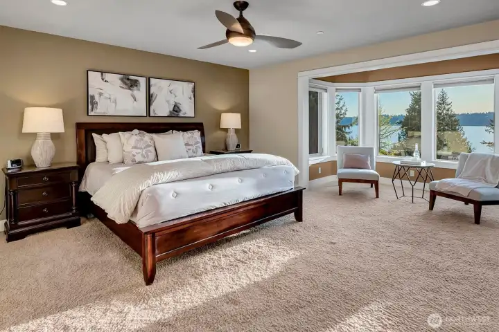 The primary suite feels like a true retreat. Generous in size with soft natural light and warm finishes, it offers plenty of space to relax and unwind. The sitting area by the windows adds an extra layer of comfort.