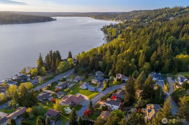 It’s not just the home-it’s where it sits. Tucked into a quiet, established neighborhood just moments from the water.