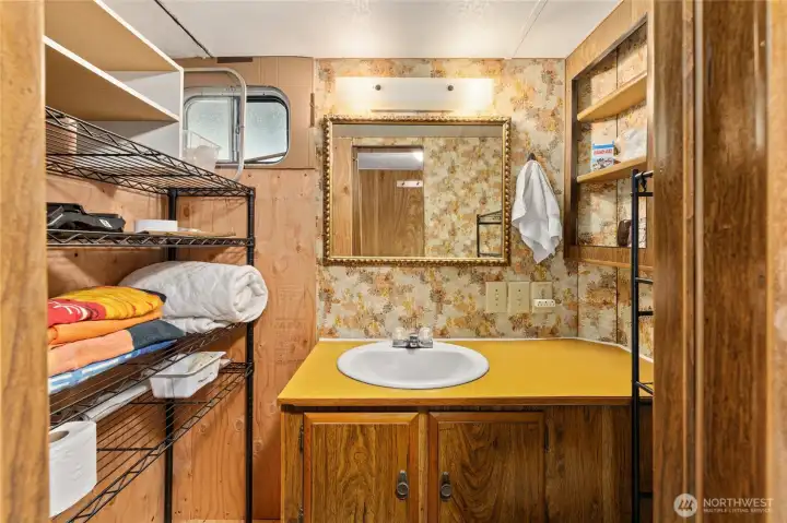 Bathroom with shelving for convenient storage.