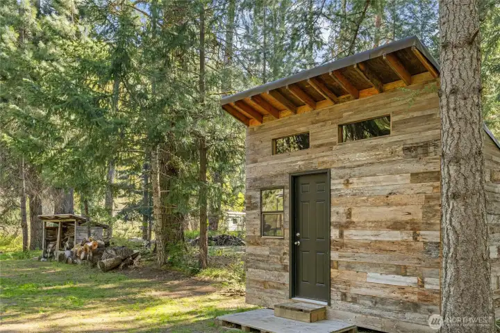 Barnwood-style shed with rustic appeal has power and water.